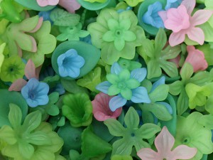 a cluster of pink blue green resin flowers and leaves