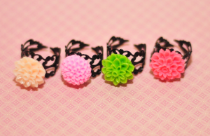 four rings with peach, orange, green and pink flowers