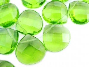 many sparkly green briollette stones on a string